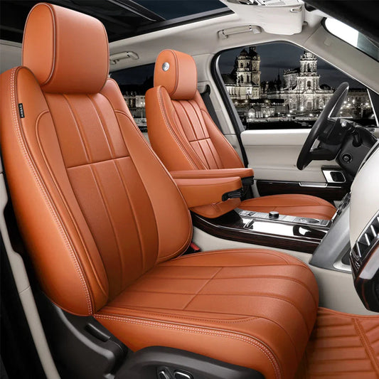 Car interior showcasing saddle brown leather front seats with white stitching and modern dashboard