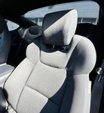 Close-up of luxury custom car seat cover with textured fabric and ergonomic design
