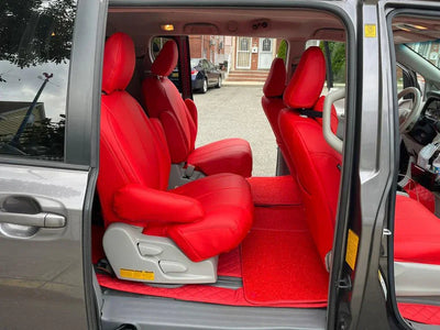 Luxury custom red seat covers installed in a gray van interior, premium car seat upgrade